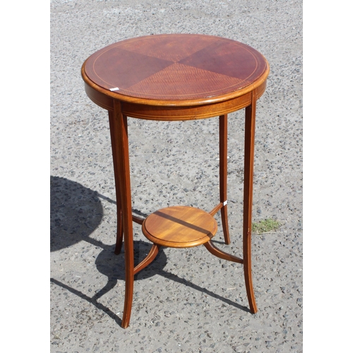 82 - A 20th century mahogany revolving bookcase and a Sheraton Revival round table (2)