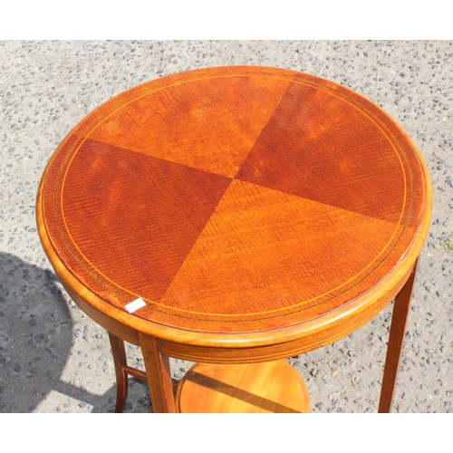 82 - A 20th century mahogany revolving bookcase and a Sheraton Revival round table (2)