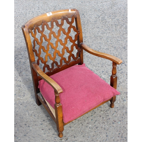 91 - An Art Deco period low armchair with unusual fretwork back