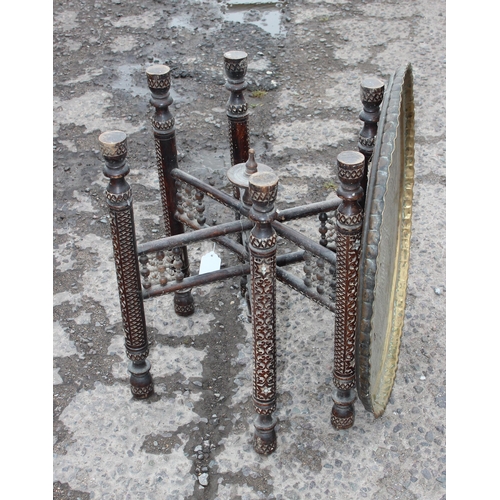 105 - A vintage Benares brass topped Bedouin tea table with folding wooden base, approx 60cm wide x 54cm t... 