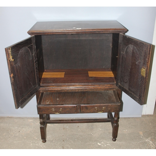 109 - An antique dark oak 2 door cabinet over 2 drawers, on turned wooden legs, likely late 19th century i... 