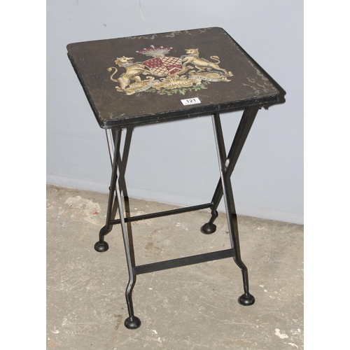 121 - A vintage style metal folding table with armorial crest