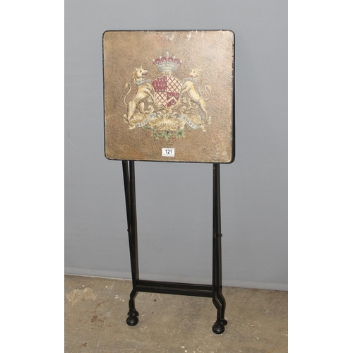 121 - A vintage style metal folding table with armorial crest