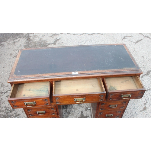 96 - A small antique 9 drawer leather topped ladies desk with brass fittings and carved details, approx 9... 
