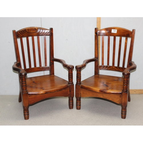 145 - Pair of vintage pitch pine children’s chairs with shaped back rest and unusual arms