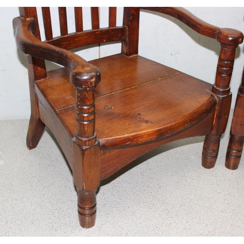 145 - Pair of vintage pitch pine children’s chairs with shaped back rest and unusual arms