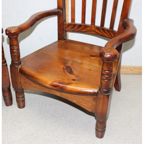 145 - Pair of vintage pitch pine children’s chairs with shaped back rest and unusual arms