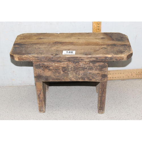 146 - A small rustic pine milking stool, approx 38cm wide