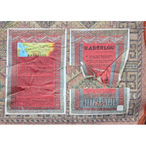 208 - A vintage Hadchlou wool rug, with labels, approx 230cm x 158cm