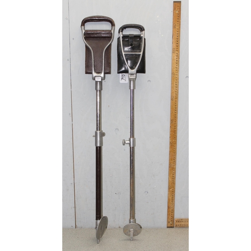 713 - Two vintage adjustable height shooting sticks with leather seating