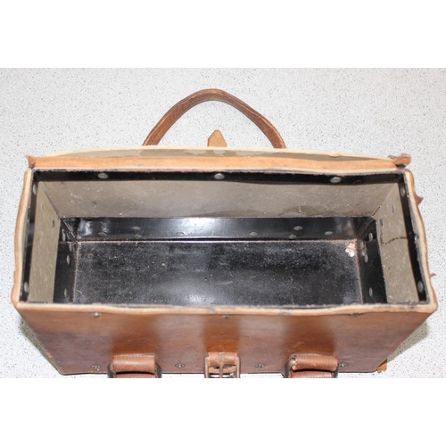 A war department issue copper riveted brown leather hide tool bag with two  carrying handles and tin