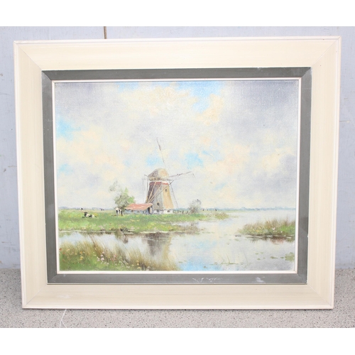 492 - Framed oil on canvas of a Dutch windmill, unsigned with framers label to verso approx 29cm x 24cm