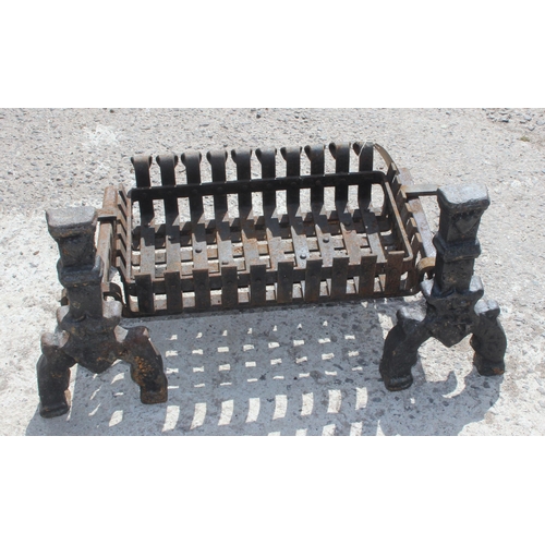 136 - A vintage cast iron fire grate and fire dogs, approx 76cm wide