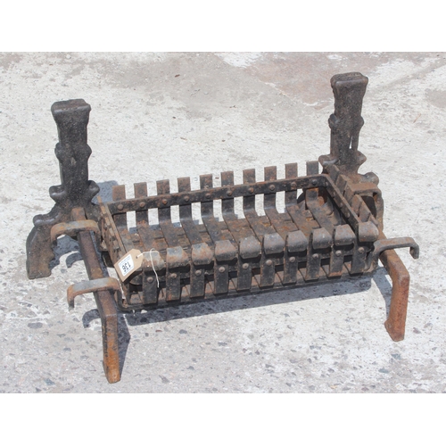 136 - A vintage cast iron fire grate and fire dogs, approx 76cm wide