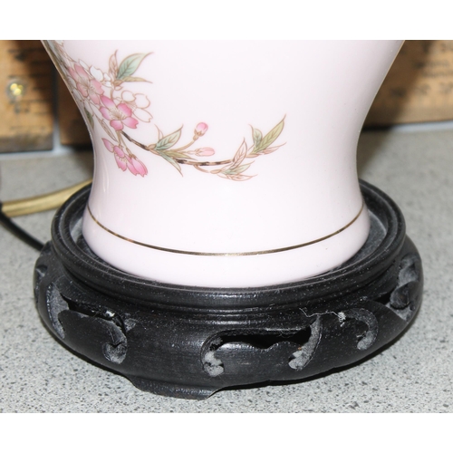 248 - A pair of Oriental pottery table lamps with pink shades, approx 59cm tall, by Lightolier