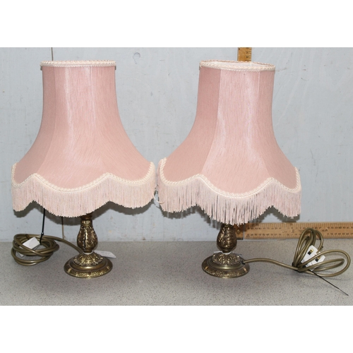 252 - A pair of vintage gilt metal table lamps with pink shades, each approx 50cm tall