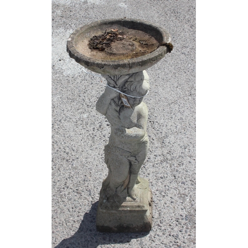 332 - A weathered concrete garden bird bath formed as a young boy holding a plinth, approx 85cm tall