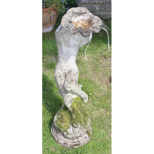 333 - A weathered concrete garden bird bath formed as a young boy holding a clam shell, approx 90cm tall