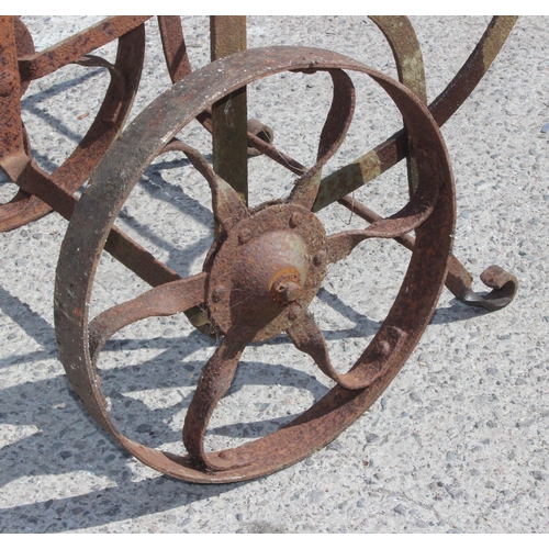 340 - A vintage wrought iron barrel trolley, approx 65cm x 110cm