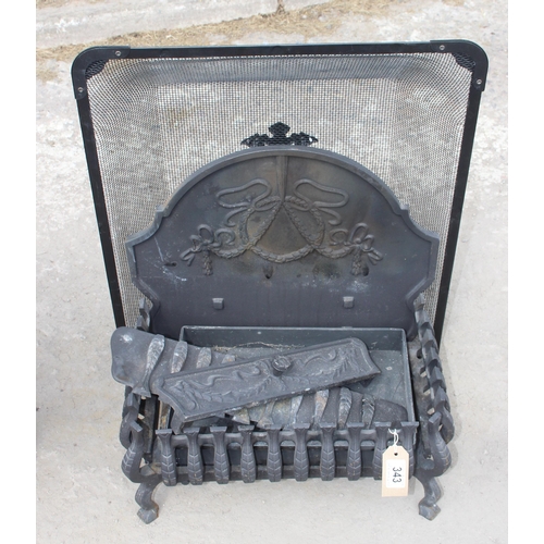 343 - A cast iron fire grate with back and spark guard