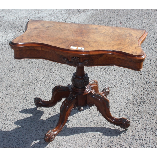 4 - A Victorian walnut fold over card table with baize line interior, with carved base and frieze, appro... 