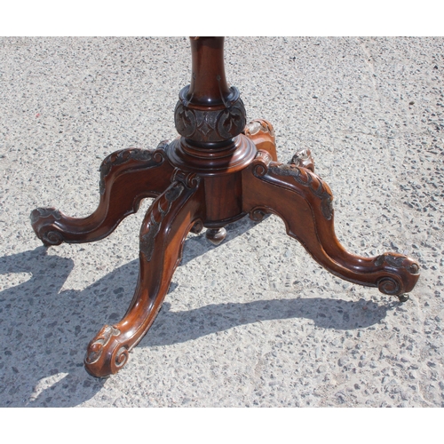 4 - A Victorian walnut fold over card table with baize line interior, with carved base and frieze, appro... 