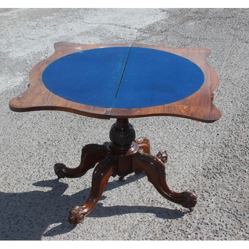 4 - A Victorian walnut fold over card table with baize line interior, with carved base and frieze, appro... 