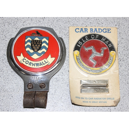 705 - A vintage Cornwall car badge and a NOS Isle of Man car badge in original packaging (2)