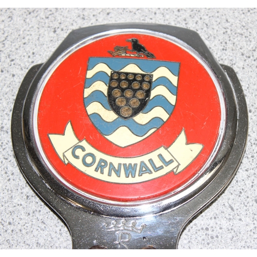 705 - A vintage Cornwall car badge and a NOS Isle of Man car badge in original packaging (2)