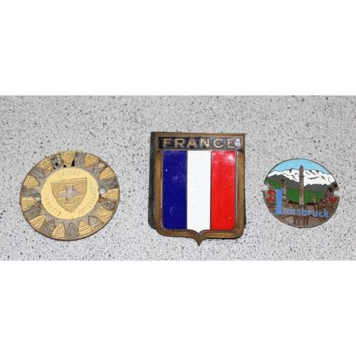 708 - A France brass and enamel car badge made by Drago of Paris & 2 other car badges, Switzerland and Inn... 