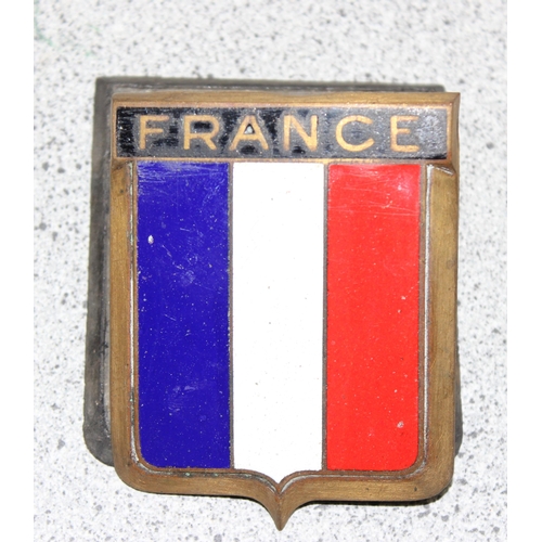 708 - A France brass and enamel car badge made by Drago of Paris & 2 other car badges, Switzerland and Inn... 