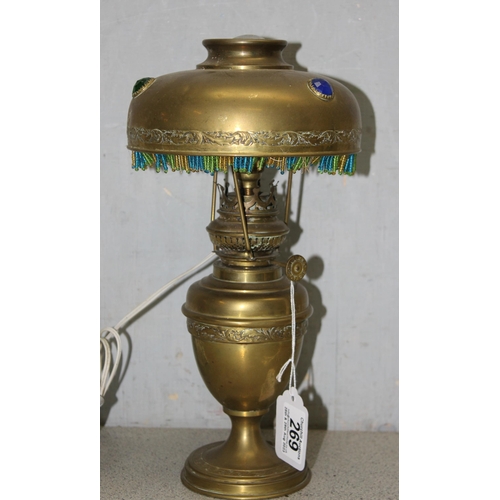 269 - A vintage brass lamp with brass shade with beadwork edging, approx 30cm tall