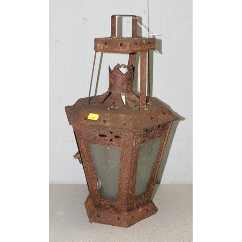 353 - 2 large weathered metal garden lanterns, the largest approx 60cm tall