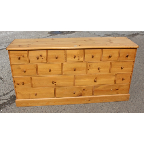 155 - A modern pine chest of drawers with 19 drawers, approx 180cm wide x 48cm deep x 94cm tall