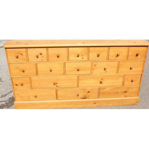 155 - A modern pine chest of drawers with 19 drawers, approx 180cm wide x 48cm deep x 94cm tall