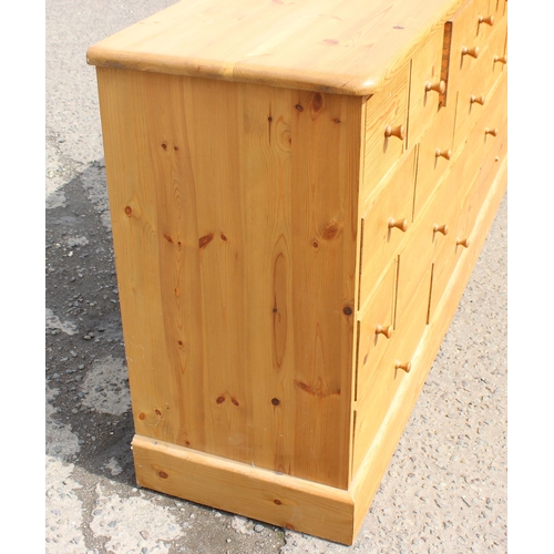 155 - A modern pine chest of drawers with 19 drawers, approx 180cm wide x 48cm deep x 94cm tall