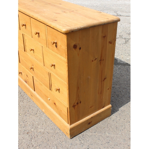 155 - A modern pine chest of drawers with 19 drawers, approx 180cm wide x 48cm deep x 94cm tall