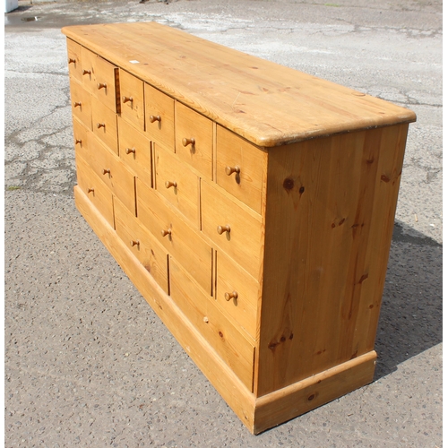 155 - A modern pine chest of drawers with 19 drawers, approx 180cm wide x 48cm deep x 94cm tall