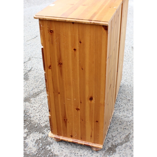 159 - A pair of modern pine 5 drawer bedside cabinets, each approx 46cm wide x 42cm deep x 98cm tall