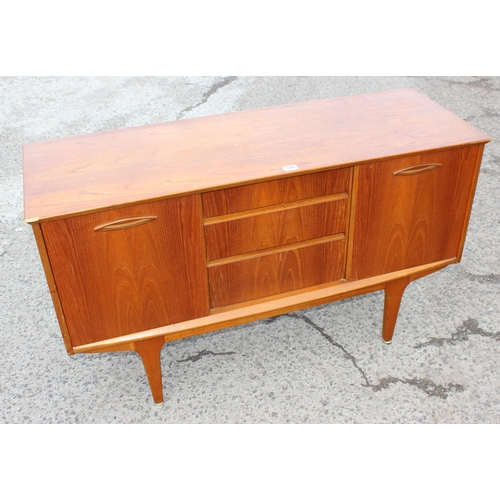 166 - A retro petite sideboard with 3 drawers flanked by 2 cupboards, seemingly unmarked but possibly Jent... 