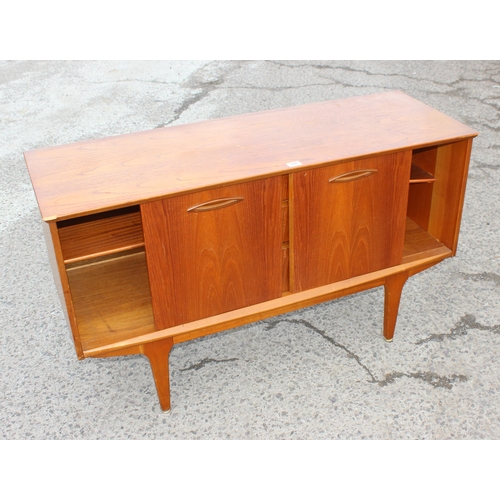 166 - A retro petite sideboard with 3 drawers flanked by 2 cupboards, seemingly unmarked but possibly Jent... 