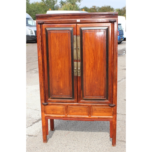 167 - A Chinese hardwood cabinet, the doors opening to reveal 3 shelves and a single drawer, likely early ... 