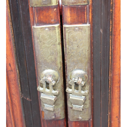 167 - A Chinese hardwood cabinet, the doors opening to reveal 3 shelves and a single drawer, likely early ... 