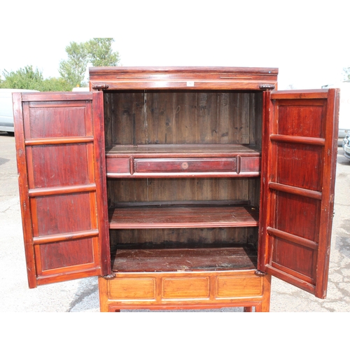 167 - A Chinese hardwood cabinet, the doors opening to reveal 3 shelves and a single drawer, likely early ... 