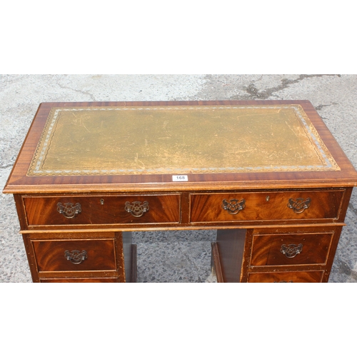 168 - A small antique style pedestal desk with green leather top and 8 drawers, approx 92cm wide x 50cm de... 