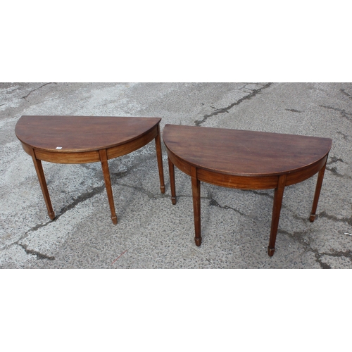 169 - A pair of antique mahogany demi-lune hall tables with spade legs, each approx 120cm wide x 57cm deep... 