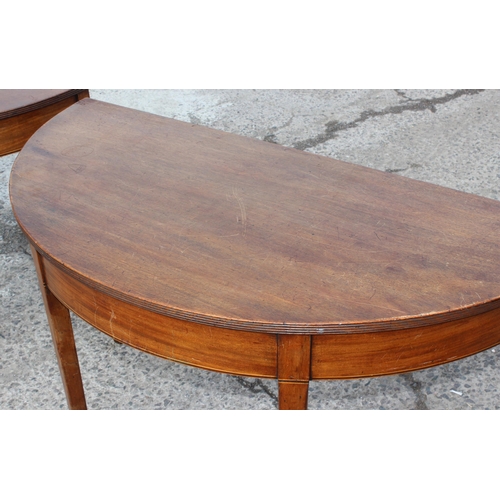 169 - A pair of antique mahogany demi-lune hall tables with spade legs, each approx 120cm wide x 57cm deep... 