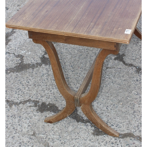 170 - A vintage tavern style table with stylised x frame legs united by a stretcher, the table with extra ... 