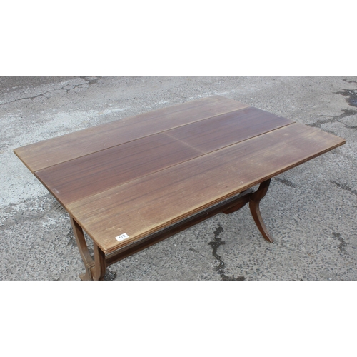 170 - A vintage tavern style table with stylised x frame legs united by a stretcher, the table with extra ... 