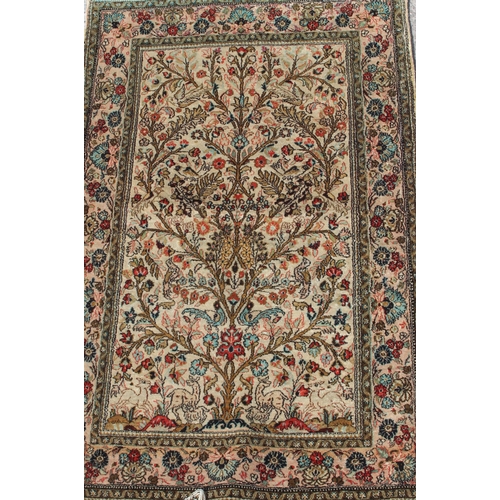 212A - A fine quality Persian Ghom silk tree of life rug, profusely decorated with deer and birds within th... 